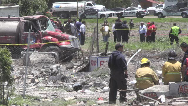 Rescue workers assess damage after the series of explosions at fireworks warehouses in the town of Tultepec, central Mexico, which led to the death of at least 19 people   