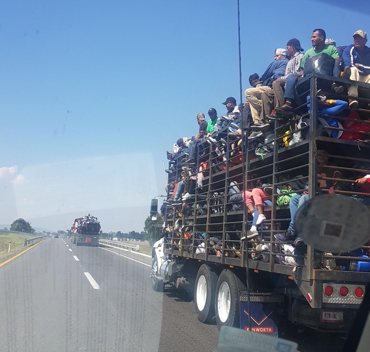 This is how migrants are traveling north on the caravan today, in trailers made for pigs and other animals. The saddest part is that their desperation to flee home and go north is so high that they are happy to have a ride at all. Photo near Irapuato, Guanajuato by @shanogayosso   